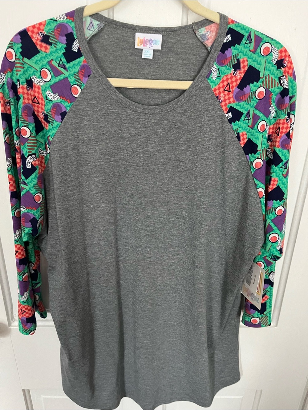 LuLaRoe Gray Raglan Top with Green, Purple and Pink Geometric Sleeves